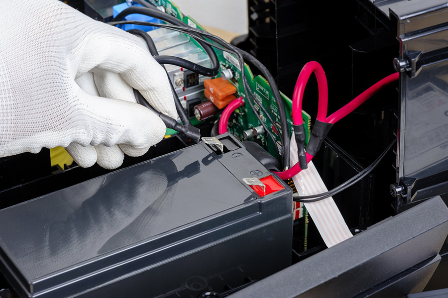 UPS tech replacing ups batteries