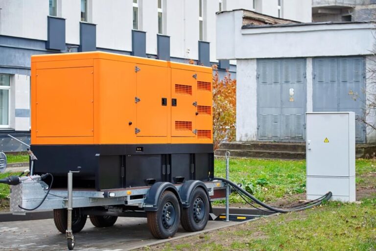 Industrial diesel generator connected to a power distribution box outside