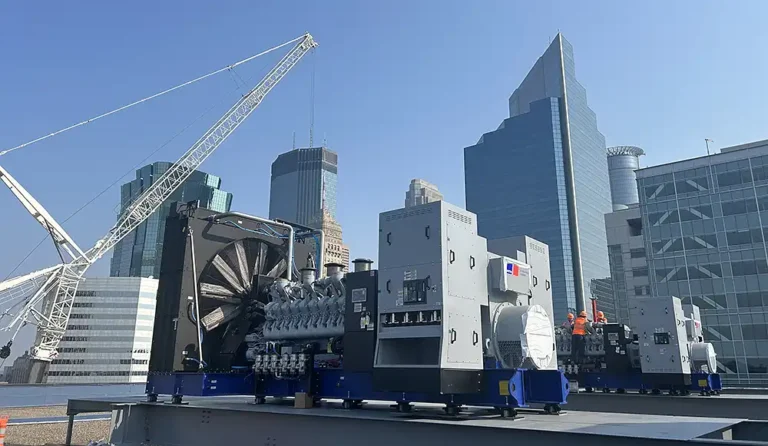 Engineers installing generators on rooftop